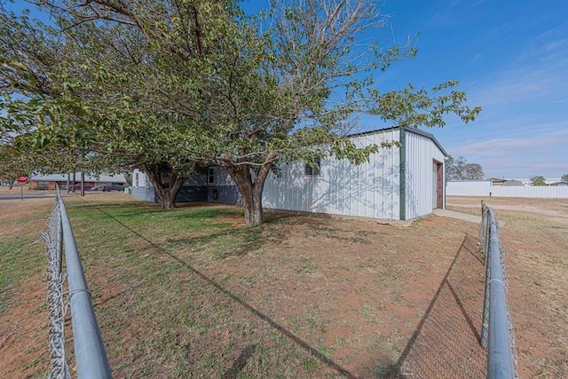 50031 E County Rd 71, Midland, TX 79705 - view of side of home featuring dirt driveway, a garage, and an outdoor structure
