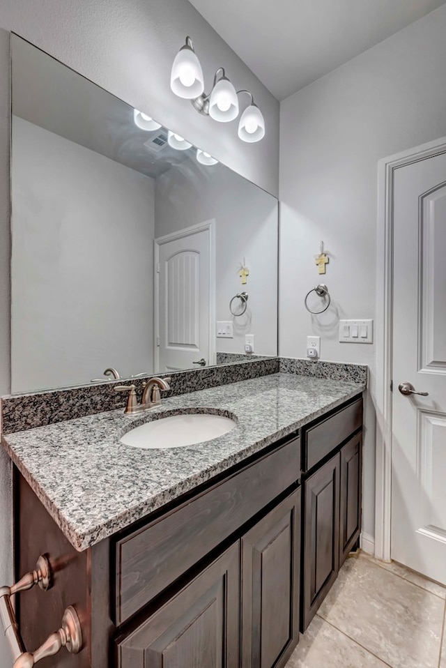 bathroom featuring tile patterned flooring and vanity