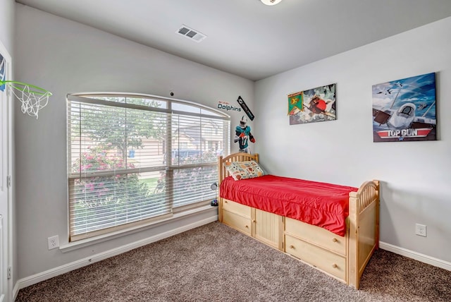 carpeted bedroom with visible vents and baseboards