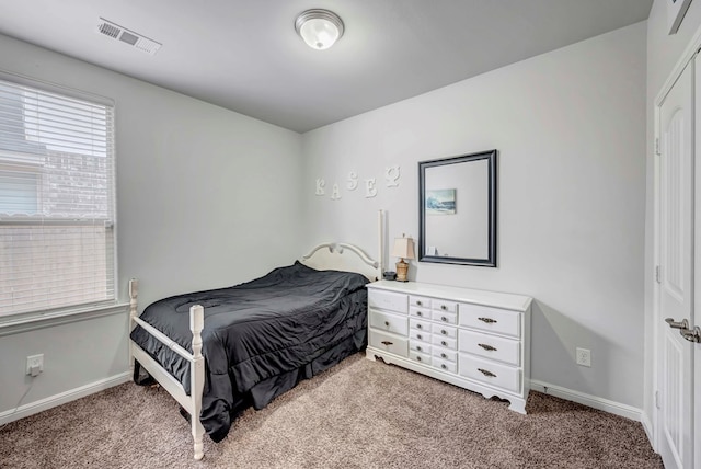 carpeted bedroom featuring visible vents and baseboards