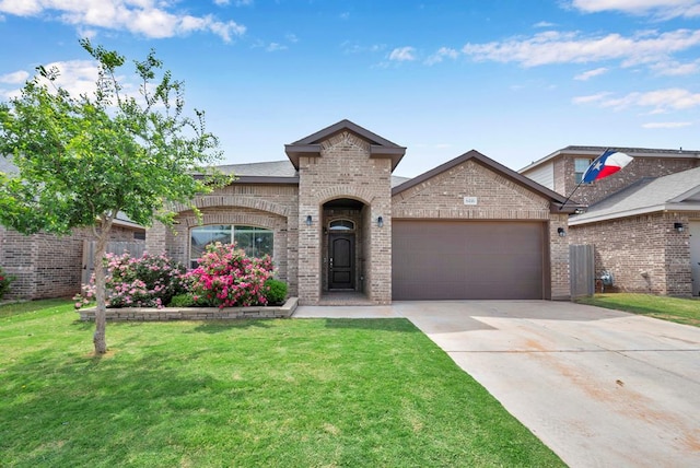 view of front of house with a garage, concrete driveway, brick siding, and a front lawn