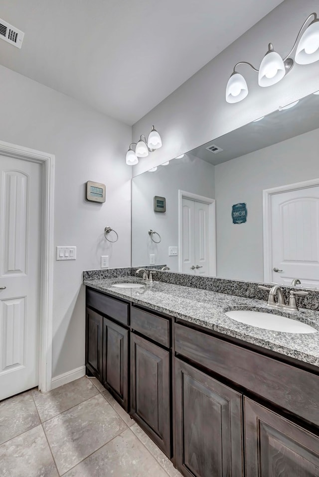 full bathroom featuring double vanity, a sink, and visible vents