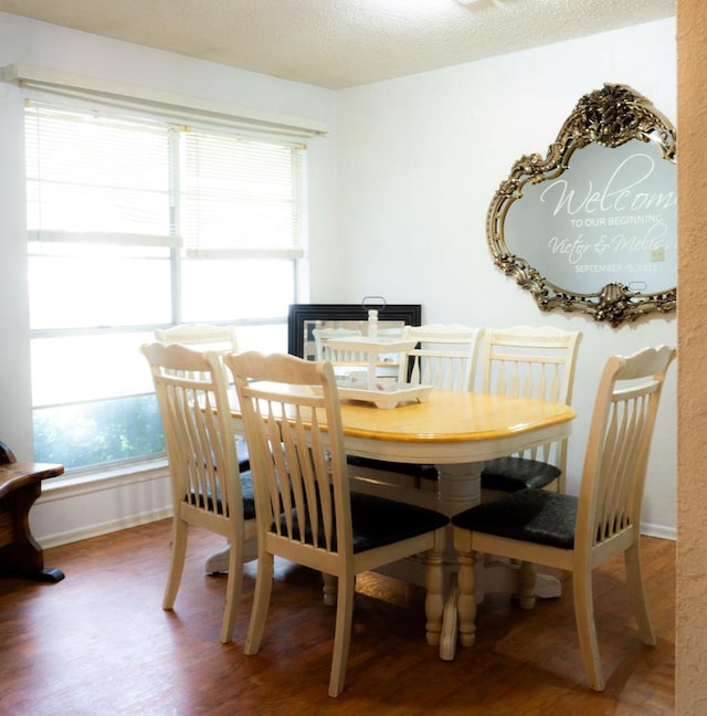 5110 Sunnyside Dr, Midland, TX 79703 - dining room featuring wood finished floors, baseboards, and a textured ceiling