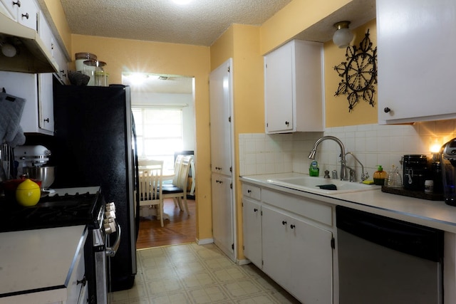 5110 Sunnyside Dr, Midland, TX 79703 - kitchen featuring dishwashing machine, a sink, light flooring, stainless steel gas stove, and white cabinets