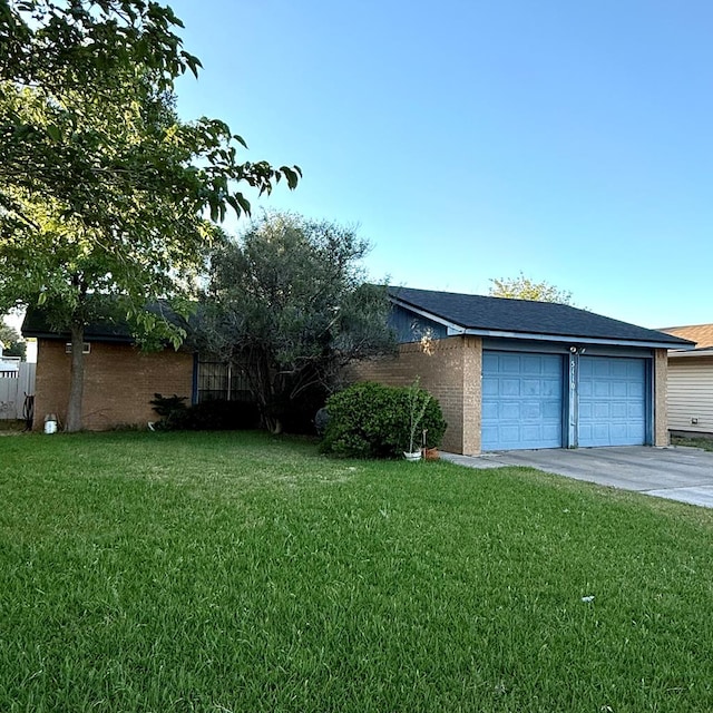 view of front facade with driveway, a front yard, a garage, and brick siding