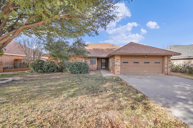 ranch-style house with a garage and a front yard