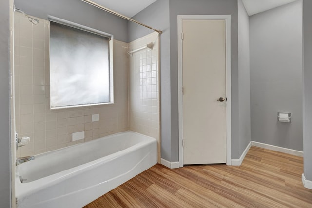 bathroom featuring tiled shower / bath combo and hardwood / wood-style floors