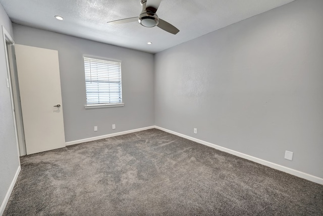 carpeted spare room featuring a textured ceiling and ceiling fan