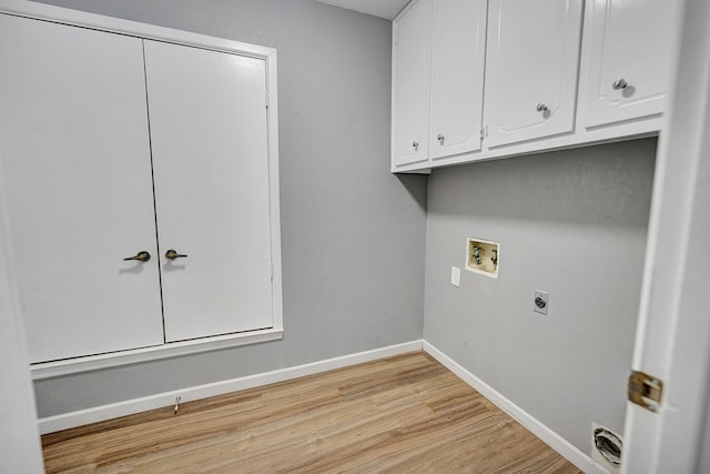 clothes washing area with cabinets, washer hookup, hookup for an electric dryer, and light hardwood / wood-style floors