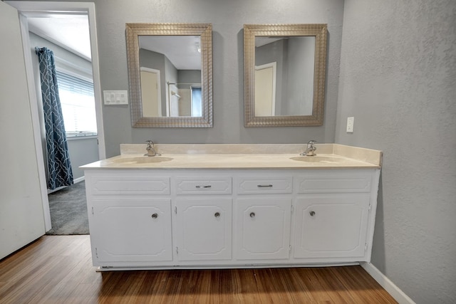 bathroom with vanity and wood-type flooring