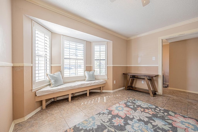 living area featuring a textured ceiling, ornamental molding, ceiling fan, and plenty of natural light