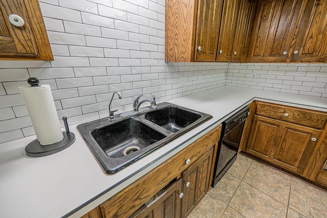 kitchen featuring sink, tasteful backsplash, and dishwasher