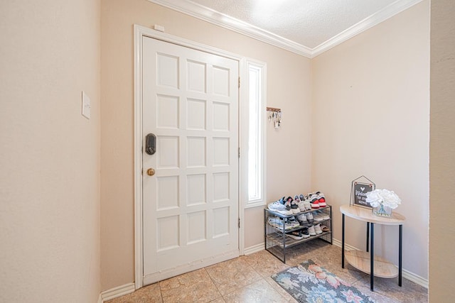 entrance foyer with ornamental molding and a textured ceiling