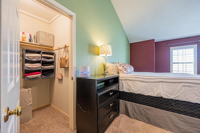 carpeted bedroom with vaulted ceiling