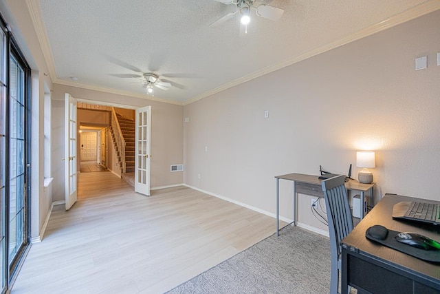 home office featuring light wood-type flooring, french doors, crown molding, and a textured ceiling