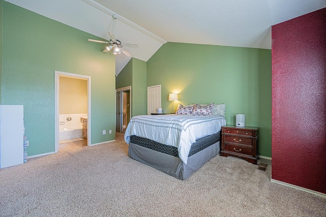 carpeted bedroom with ceiling fan, high vaulted ceiling, and ensuite bath