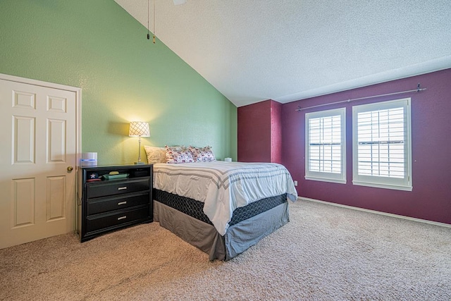 carpeted bedroom featuring a textured ceiling and lofted ceiling