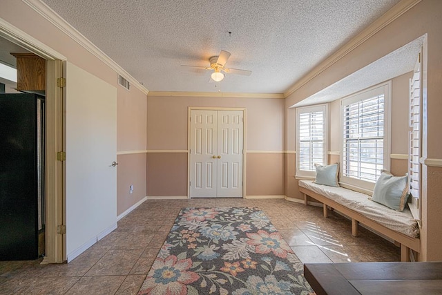 interior space featuring ceiling fan, crown molding, and a textured ceiling