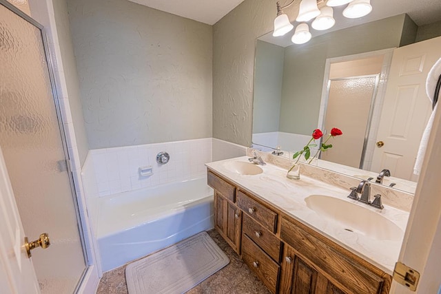 bathroom featuring vanity and independent shower and bath