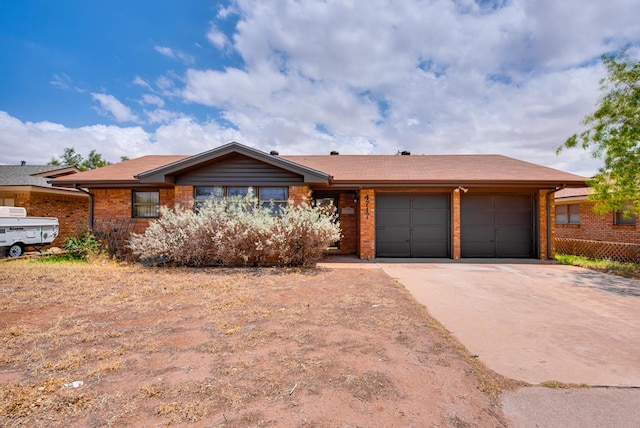 4717 W Illinois Ave, Midland, TX 79703 - ranch-style house featuring an attached garage, brick siding, and driveway