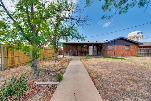 4717 W Illinois Ave, Midland, TX 79703 - rear view of house with a fenced backyard and brick siding
