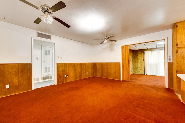 4717 W Illinois Ave, Midland, TX 79703 - carpeted spare room featuring ceiling fan, wooden walls, and wainscoting