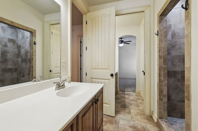 5001 Crista Ln, Midland, TX 79707 - full bathroom featuring vanity, ceiling fan, and tiled shower