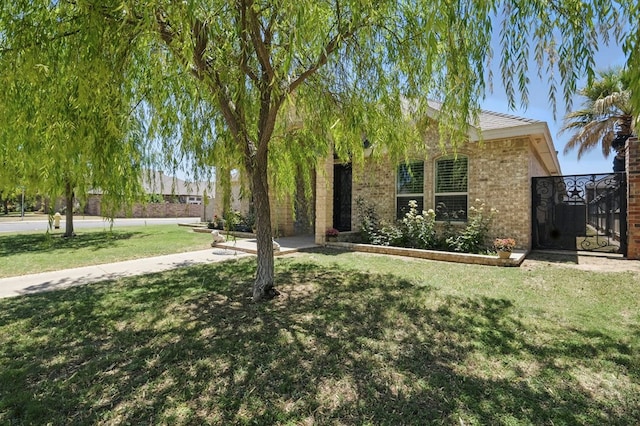 5001 Crista Ln, Midland, TX 79707 - view of front of property featuring a front yard and brick siding