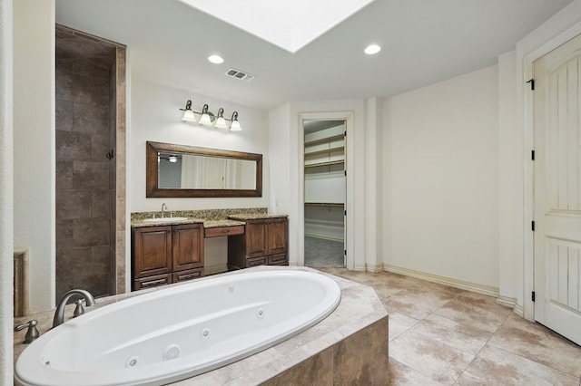 5001 Crista Ln, Midland, TX 79707 - bathroom with a jetted tub, vanity, recessed lighting, and baseboards