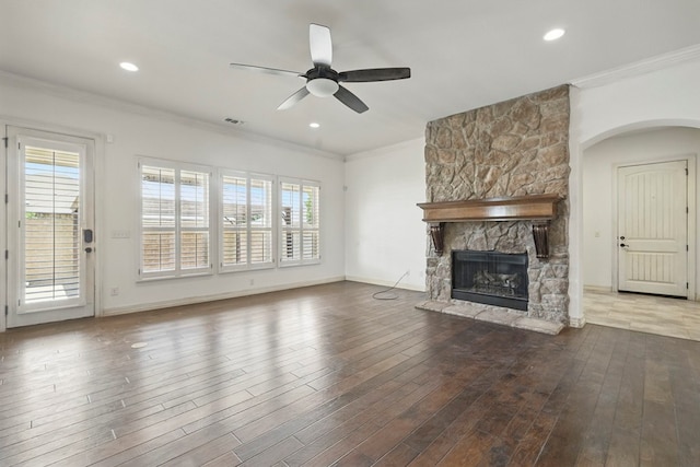 5001 Crista Ln, Midland, TX 79707 - unfurnished living room with ceiling fan, a fireplace, ornamental molding, healthy amount of natural light, and wood finished floors