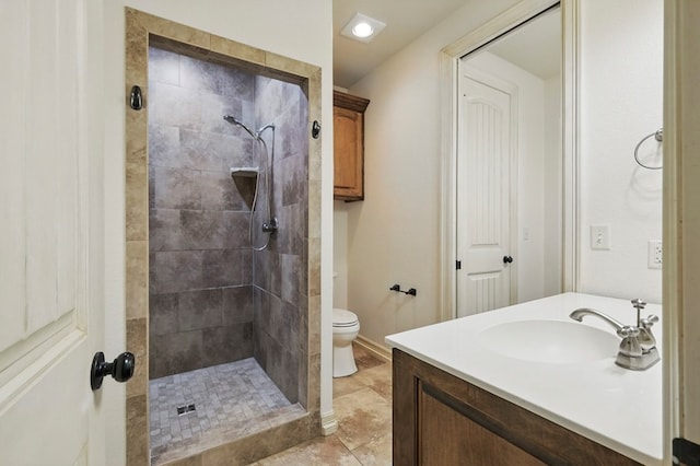 5001 Crista Ln, Midland, TX 79707 - full bathroom with tiled shower, vanity, toilet, and tile patterned flooring