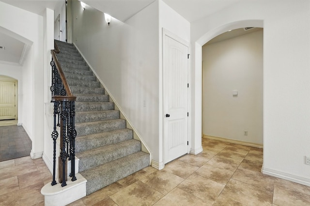 5001 Crista Ln, Midland, TX 79707 - staircase featuring arched walkways and baseboards