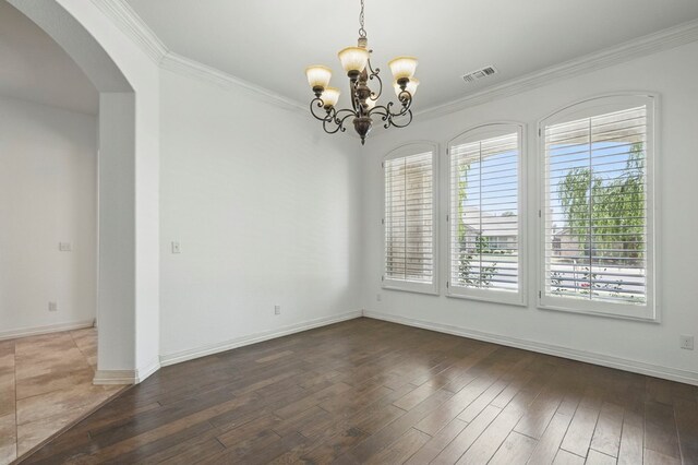 5001 Crista Ln, Midland, TX 79707 - unfurnished room with arched walkways, ornamental molding, a chandelier, hardwood / wood-style floors, and baseboards