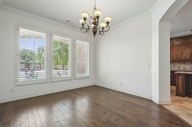 5001 Crista Ln, Midland, TX 79707 - unfurnished dining area featuring arched walkways, a chandelier, light wood finished floors, ornamental molding, and baseboards