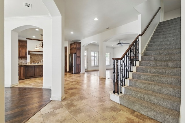 5001 Crista Ln, Midland, TX 79707 - entrance foyer featuring a ceiling fan, arched walkways, stairway, recessed lighting, and ornamental molding