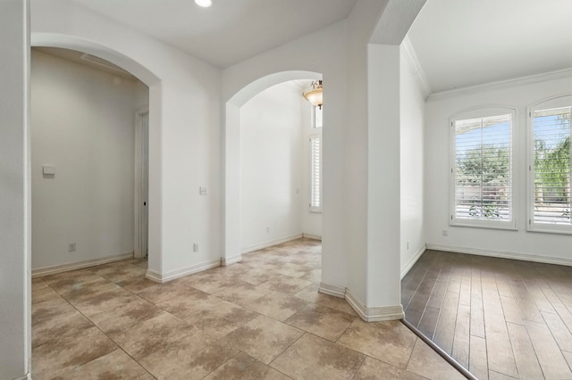5001 Crista Ln, Midland, TX 79707 - unfurnished room with arched walkways, ornamental molding, and baseboards
