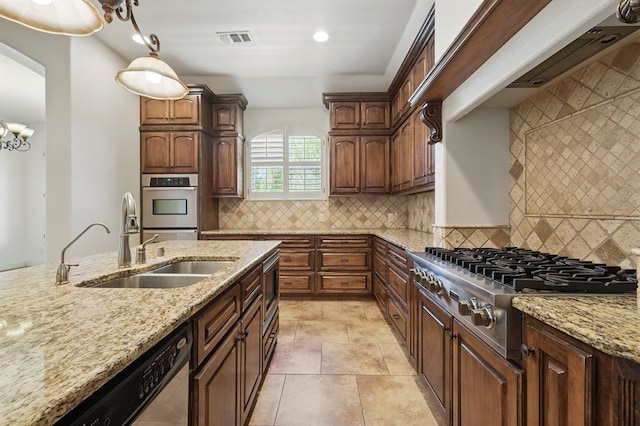 5001 Crista Ln, Midland, TX 79707 - kitchen with appliances with stainless steel finishes, light stone counters, a sink, decorative backsplash, and recessed lighting