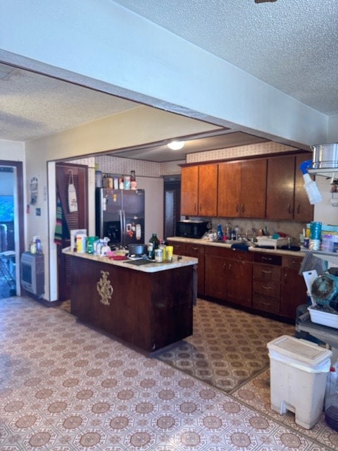 1510 S Fort Worth, Midland, TX 79701 - kitchen with fridge with ice dispenser, a textured ceiling, and light countertops