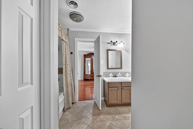 2409 Stutz Pl, Midland, TX 79705 - full bathroom with vanity, tile patterned flooring, crown molding, shower / bathtub combination with curtain, and tasteful backsplash