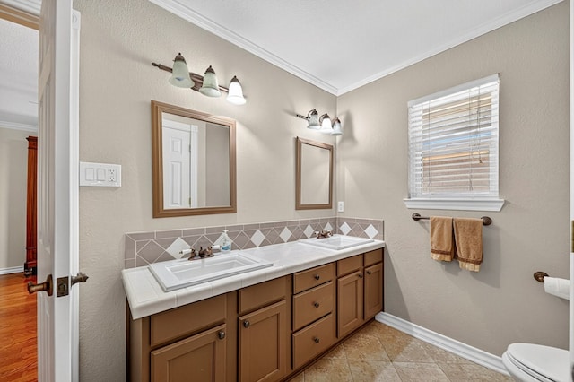 2409 Stutz Pl, Midland, TX 79705 - bathroom with crown molding, double vanity, and decorative backsplash
