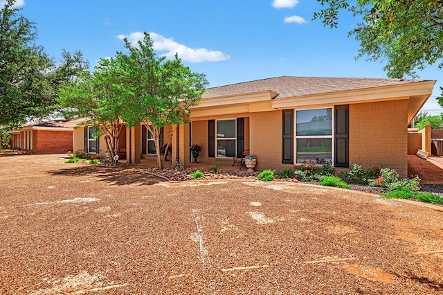 2409 Stutz Pl, Midland, TX 79705 - ranch-style home featuring brick siding, a porch, and a shingled roof