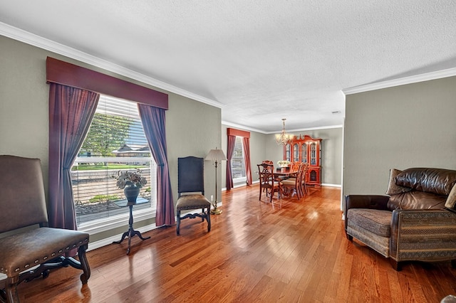 2409 Stutz Pl, Midland, TX 79705 - living area featuring a chandelier, crown molding, wood finished floors, plenty of natural light, and a textured ceiling