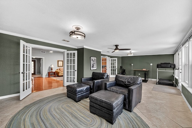 2409 Stutz Pl, Midland, TX 79705 - living room featuring french doors, light tile patterned flooring, a ceiling fan, ornamental molding, and a textured ceiling