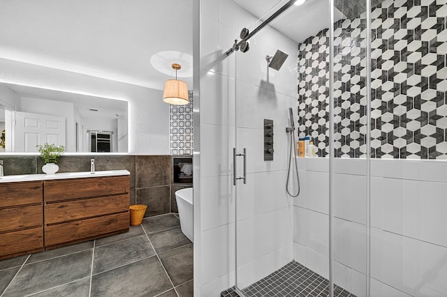 2409 Stutz Pl, Midland, TX 79705 - full bathroom with tile walls, a shower stall, double vanity, a soaking tub, and tile patterned flooring