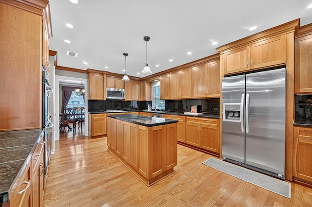 2409 Stutz Pl, Midland, TX 79705 - kitchen featuring appliances with stainless steel finishes, light wood-style flooring, tasteful backsplash, recessed lighting, and a kitchen island