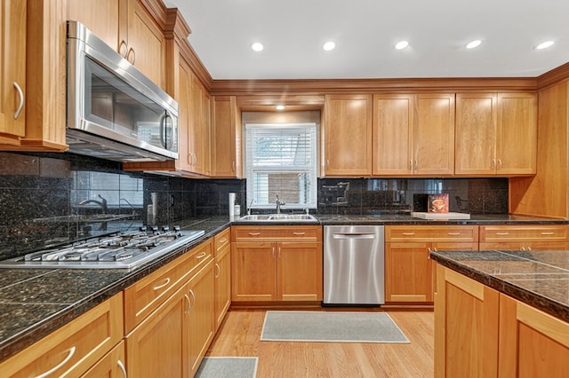 2409 Stutz Pl, Midland, TX 79705 - kitchen featuring stainless steel appliances, light wood-type flooring, tasteful backsplash, recessed lighting, and tile countertops