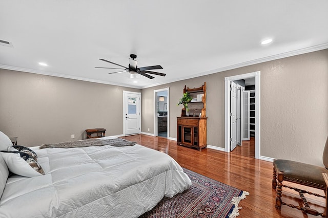 2409 Stutz Pl, Midland, TX 79705 - bedroom featuring crown molding, a spacious closet, recessed lighting, wood finished floors, and a ceiling fan