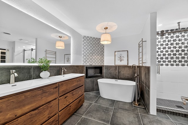2409 Stutz Pl, Midland, TX 79705 - full bathroom with tile walls, a stall shower, double vanity, a soaking tub, and tile patterned floors