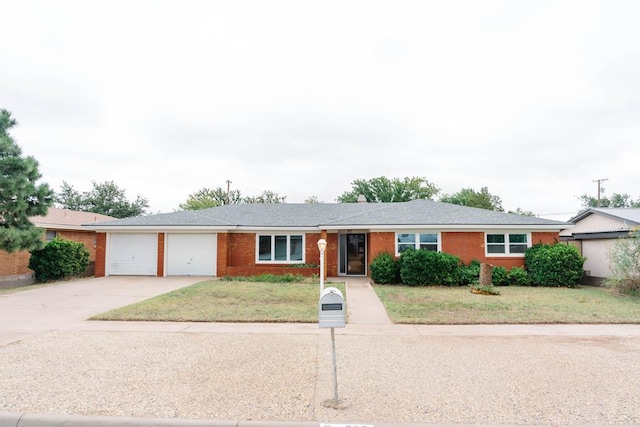 single story home featuring a front lawn and a garage