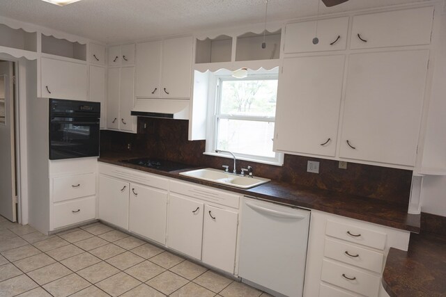 kitchen with black oven, white cabinetry, dishwasher, and sink